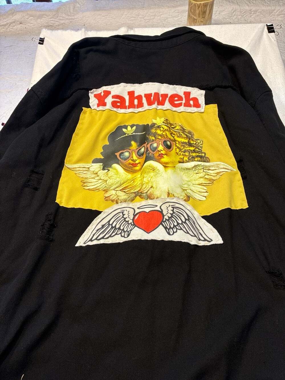 Yahweh Distressed Black Denim Jacket with Cherub Graphic